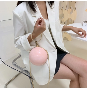 Pink round hard shell evening bag with rhinestone ring handle and gold chain strap