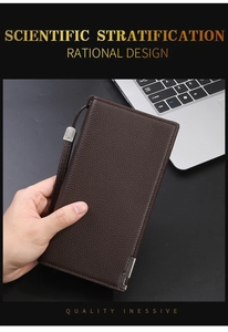 Detail of dark brown long wallet with litchi grain leather texture held in hand