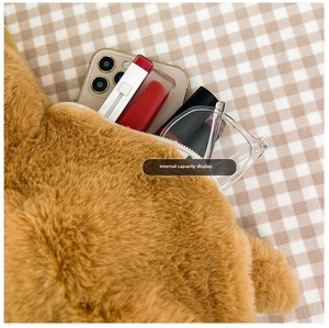 Internal capacity display of cute brown plush dog bag with soft texture and smooth zipper
