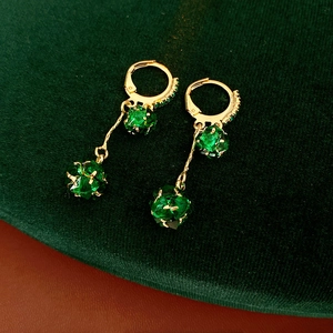Vintage style gold earrings featuring emerald green crystal beads and tassel drop design