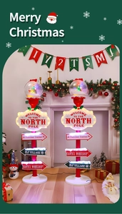 Illuminated Christmas street sign decor featuring North Pole and Santa's Workshop direction