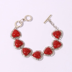 Detail view of heart-shaped red turquoise stones in retro silver-toned metal frames