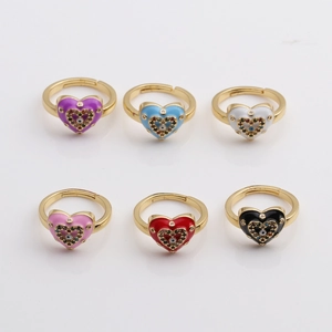Detail of colorful enamel heart rings with evil eye design and gold plating