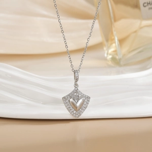 Silver heart pendant necklace with micro-set zircon frame on white display board