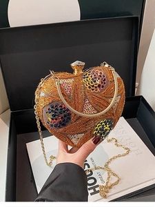 Luxurious gold heart-shaped clutch bag with intricate sequin beadwork and chain strap