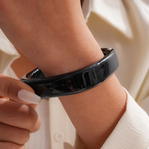 Detailed view of a stylish black resin square bangle bracelet worn on the wrist