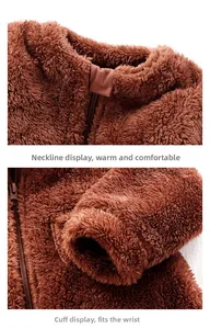 Detail of baby plush jumpsuit showing zipper neckline and elastic cuffs for warmth