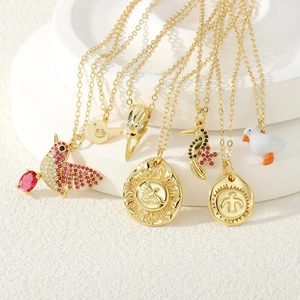 Macro shot of gold-plated eagle disk pendants with micro-pave cubic zirconia and enamel