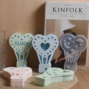 Detail showing various heart-shaped hot air balloon silicone molds with Glück engraving