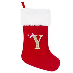 Detail of red velvet Christmas stocking with white faux fur cuff and gold sequined letter Y