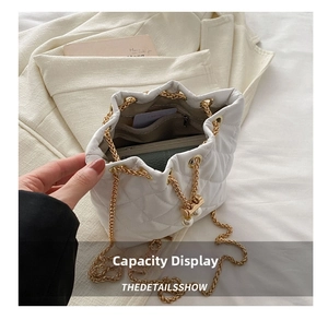 Interior view of white quilted bucket bag showing storage capacity and internal pockets