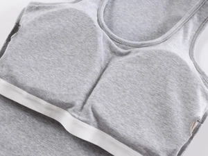 Detail of grey knitted sports tank top showing soft cotton texture and built-in bra pads