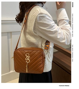 Brown quilted camera bag with wide ethnic strap and gold tassel detail