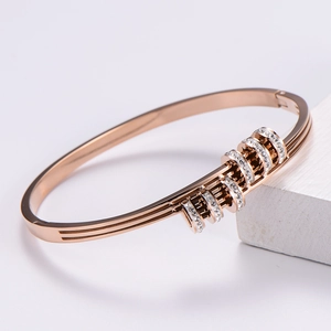 Detail of rose gold slide bracelet with five sparkling crystal-encrusted rings