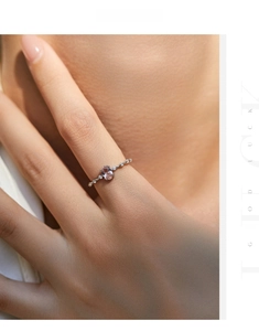 Detailed shot of an oval pink crystal ring in s925 silver with delicate micro-pave stones