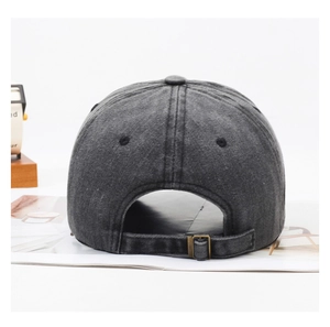Detail of vintage washed cotton baseball cap with adjustable bronze metal buckle