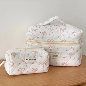 Quilted cotton cosmetic bags in white with pink bow pattern and dual zipper closure