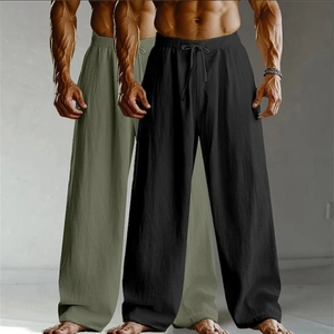 Detail of loose fit linen pants featuring drawstring waistband and wide leg cut for men