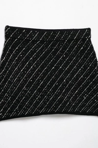 Close-up of black knit fabric texture with white tweed stripe patterns for elegant suit sets