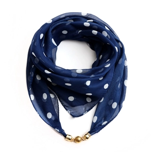 Detailed shot of blue chiffon square scarf with white dots and gold magnetic ball clasp