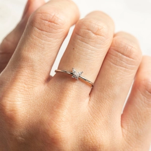 Close-up of a silver butterfly ring with colorful zircon stones on a model's finger
