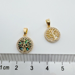18k gold plated tree of life pendant with white shell and zircons shown on a ruler
