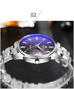 Macro detail of men's silver stainless steel watch with blue anti-reflective glass