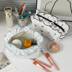 Quilted bow makeup bag with ruffle trim and soft fabric texture for students