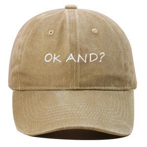 Detail of vintage washed khaki cotton baseball cap with white OK AND embroidered text