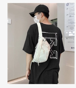 Rear view of a white nylon chest bag for men with drawstring pockets and wide strap