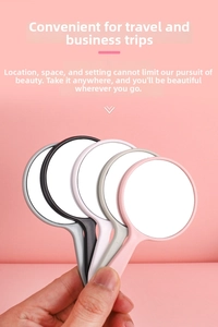 Close-up of portable mini handheld makeup mirrors in four colors with ergonomic handles
