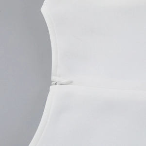 Detailed close-up of seamless invisible zipper on a white summer A-line mini dress