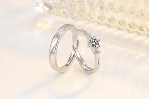 Detail of adjustable couple rings featuring a sparkling moissanite main stone and twisted band