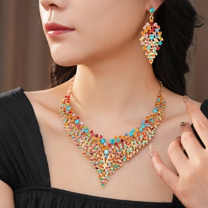 Close-up of vintage gold leaf jewelry set with colorful rhinestones on a model