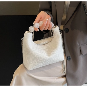 Detail of white textured leather dumpling bag with bubble pearl handle and silver chain