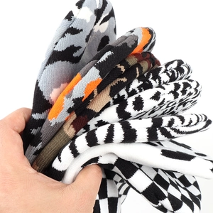 Variety of thick knit socks featuring camouflage, leopard print, and checkerboard patterns