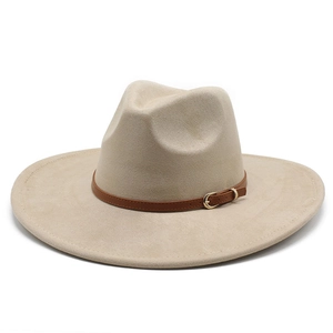 Detailed close-up of beige suede fedora with brown leather band and gold metal buckle