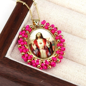 Religious Jesus portrait pendant necklace with colorful beads and golden metal accents
