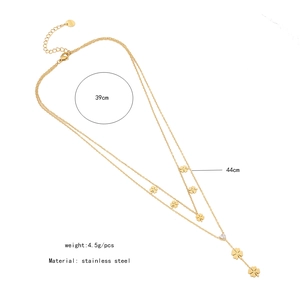 Detail of double-layer stainless steel necklace with clover charms and heart pendant