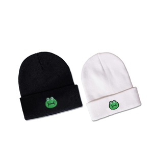 Minimalist knitted beanie with green frog embroidery in black and white styles
