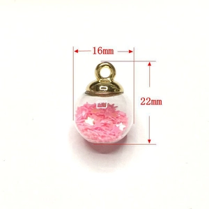 Detail showing a 16mm x 22mm clear glass sphere charm with pink star sequins inside