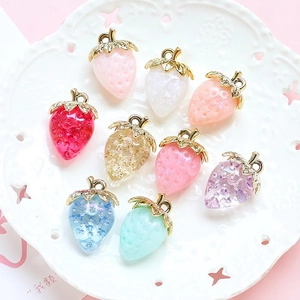 Acrylic crystal strawberry pendants in various colors with golden metal leaf charms