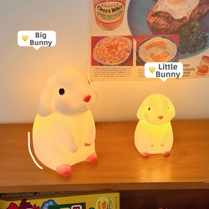 Detailed view of large and small cute bunny night lights in a cozy indoor setting