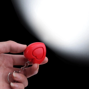 Red heart-shaped personal safety alarm with LED flashlight and metal keychain