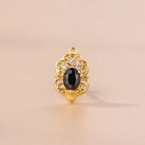 Detailed view of a vintage gold earring with an oval black zircon and clear crystals