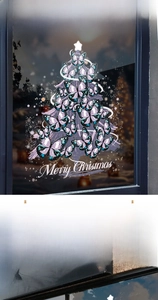 Detail of Christmas tree window sticker made of purple butterflies with a star topper