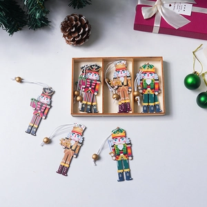 Three hand-painted wooden nutcracker soldier ornaments in a rustic wooden gift storage box