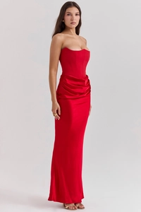 Close-up of elegant red satin formal dress with corset bodice and pleated waist detail