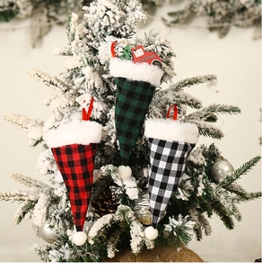 Detail of plaid Christmas hat utensil holders with truck charm on snowy tree