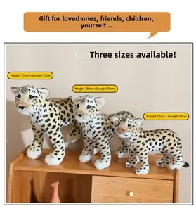 Three sizes of realistic leopard plush toys arranged by height on a wooden cabinet